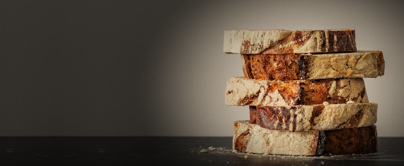 Stack of sourdough slices on a dark counter